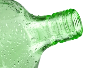 Green empty bottle. Closeup, isolated on white background